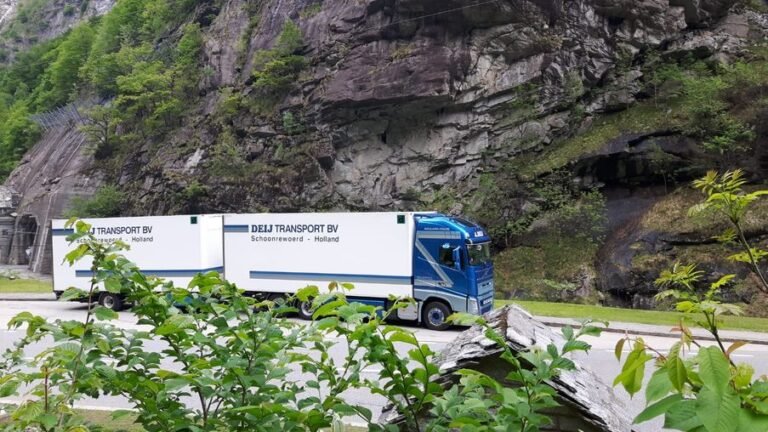 Vrachtwagen van Deij Transport langs een begroeide rotswand